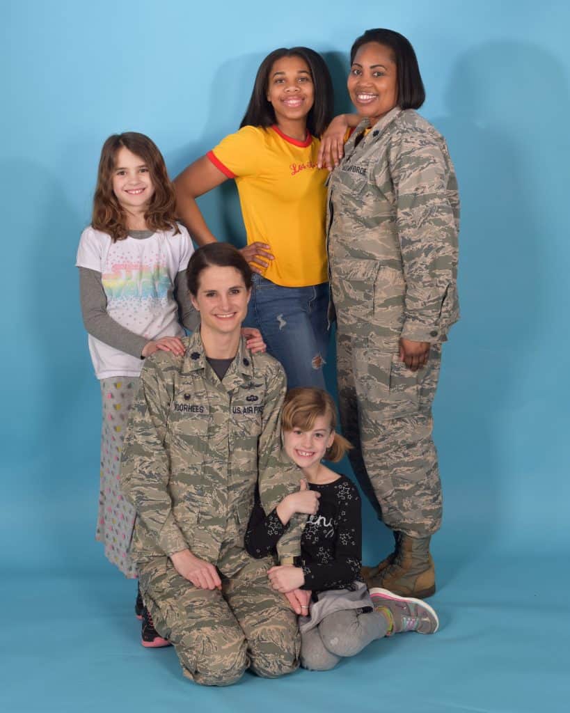 Lt. Col. Stacie Voorhees, left, 100th Communications Squadron commander, and Lt. Col. Carina Harrison, 100th Force Support Squadron commander, pose with their daughters at RAF Mildenhall, England, Feb. 23, 2018. These leaders tell their story on how they surpass the sometimes colliding responsibilities of family and duty. (U.S. Air Force photo by Airman 1st Class Alexandria Lee)