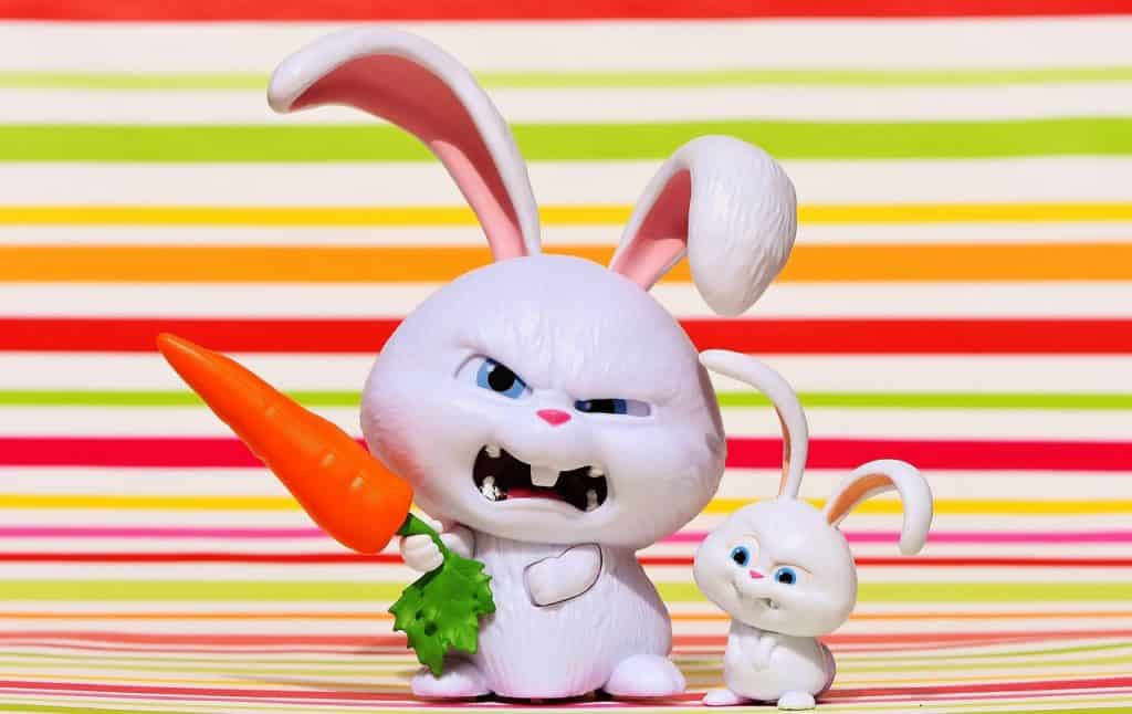 Angry white rabbit with carrot and baby rabbit